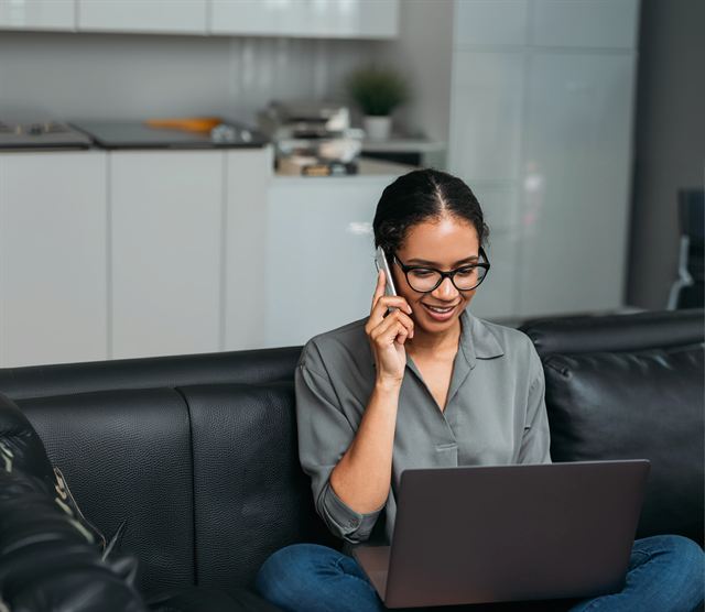 A SmarterTech member getting help over the phone while working on her laptop