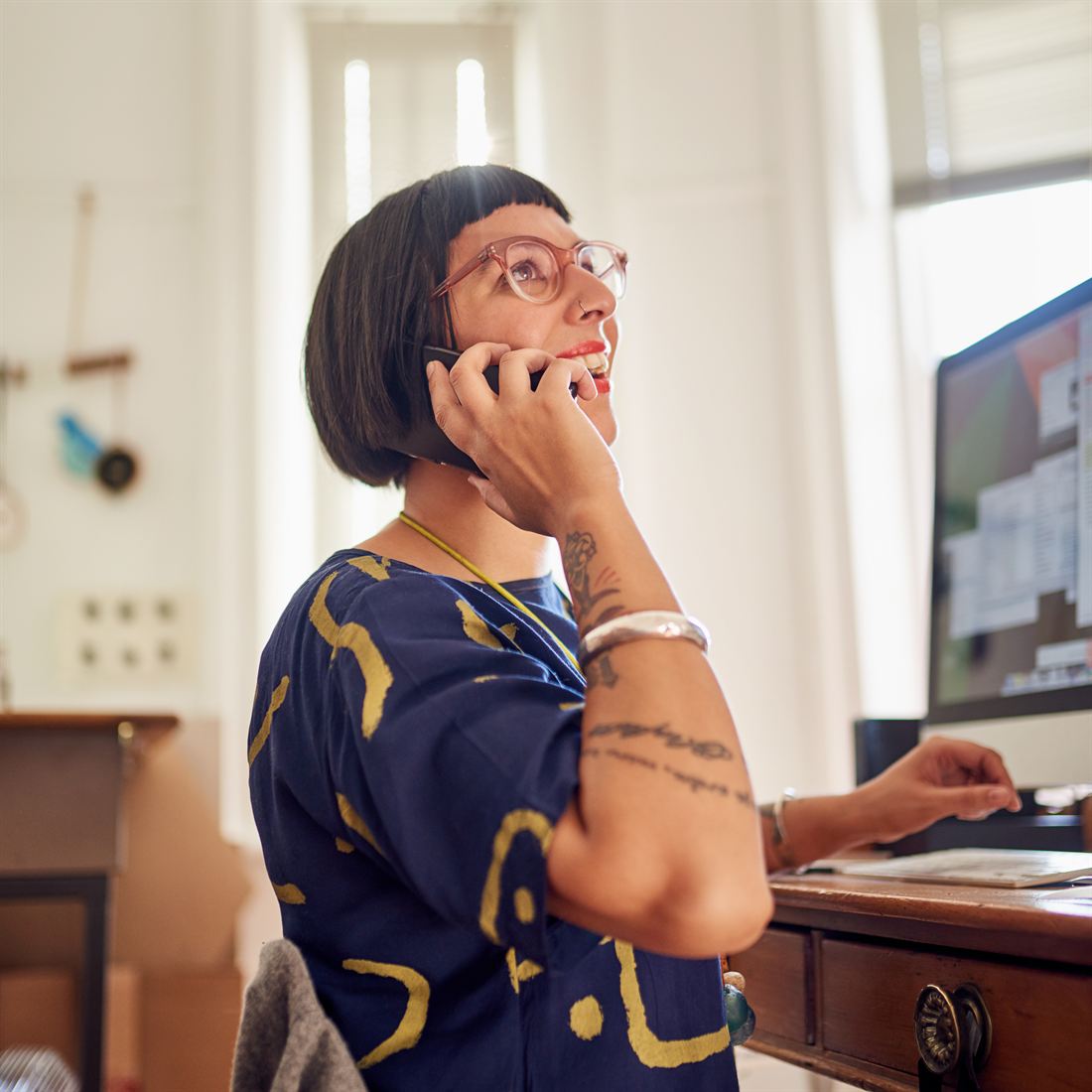 A SmarterTech member on a support call at her desk